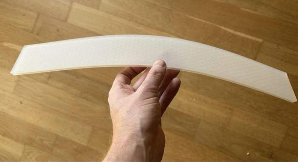 A single soft-touch slat held in one hand